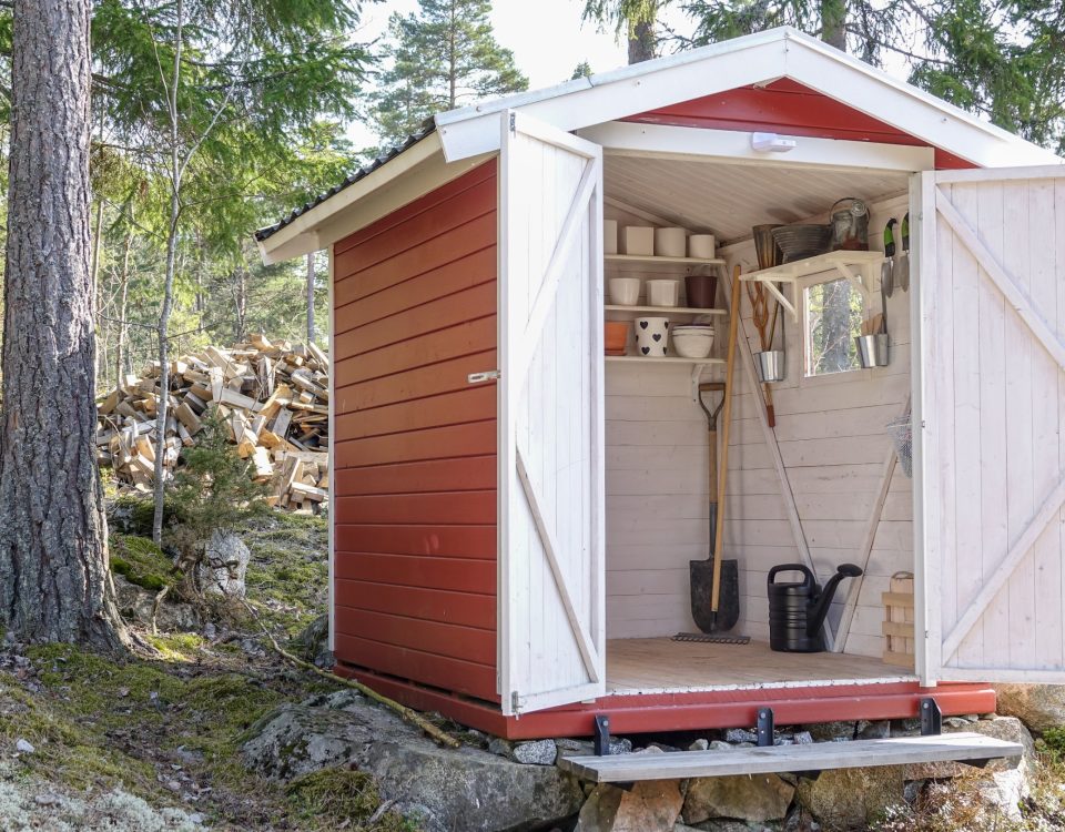 Garden shed with open doors on property.