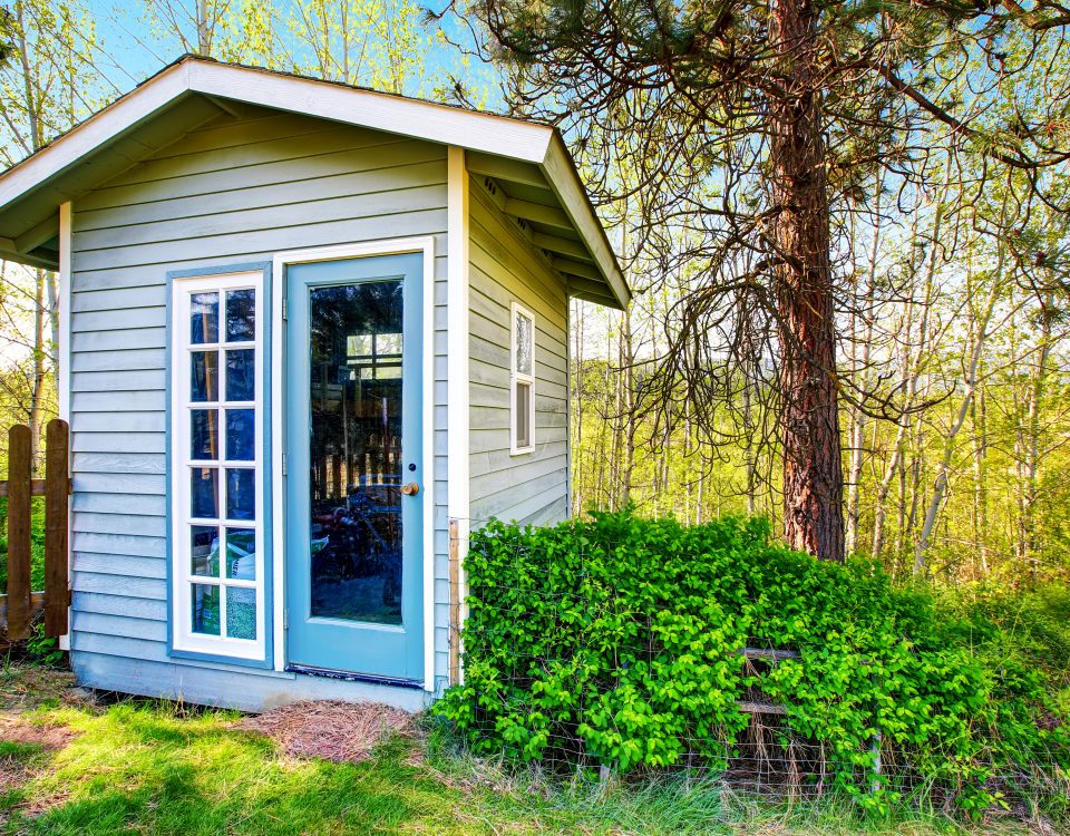 Storage shed in backyard next to garden